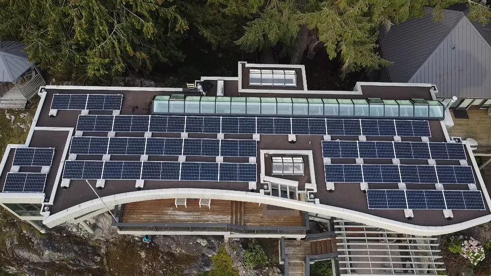 Ballast mounted solar array on a waterfront flat roof home on Bowen Island
